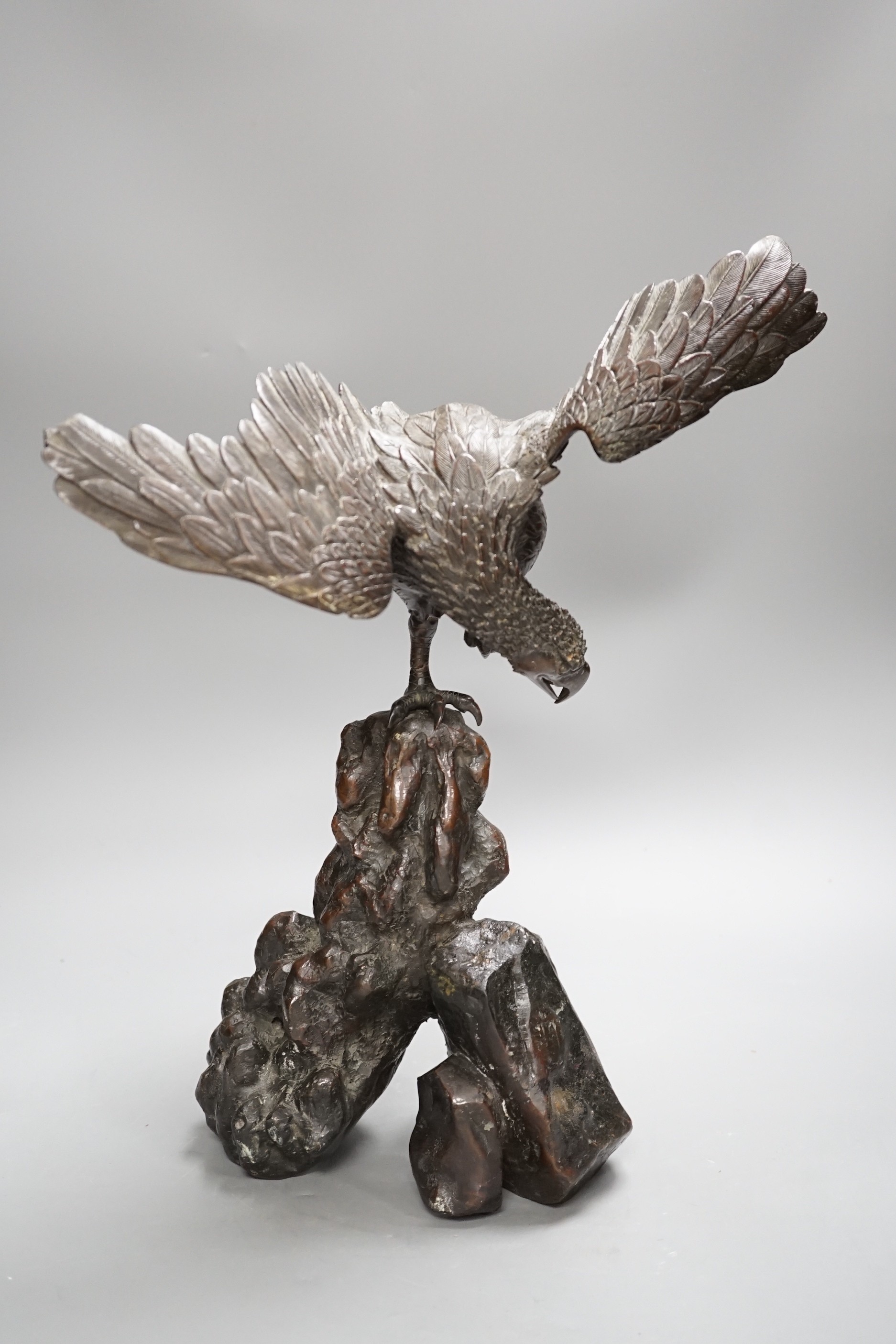 A Japanese bronze model of an eagle on a rock, Meiji period, 40cms high.